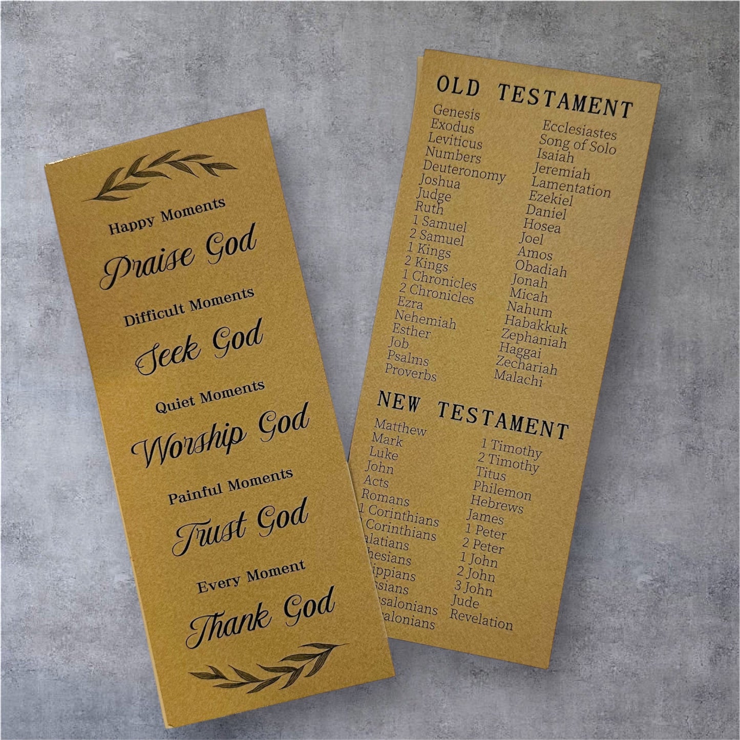 Two prayer bookmarks on a gray background, one titled 'Happy Moments' and the other listing books of the Bible.