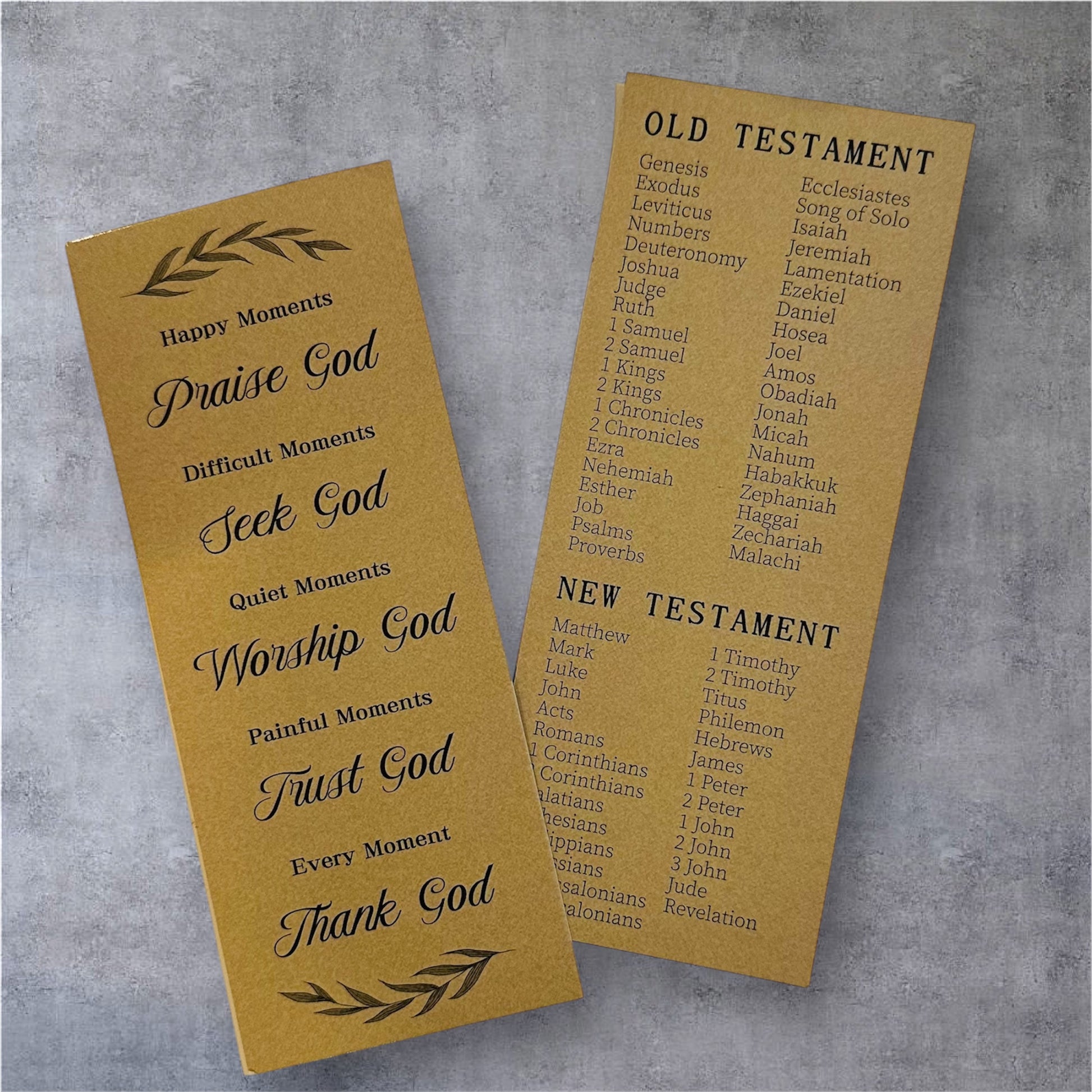 Two prayer bookmarks on a gray background, one titled 'Happy Moments' and the other listing books of the Bible.